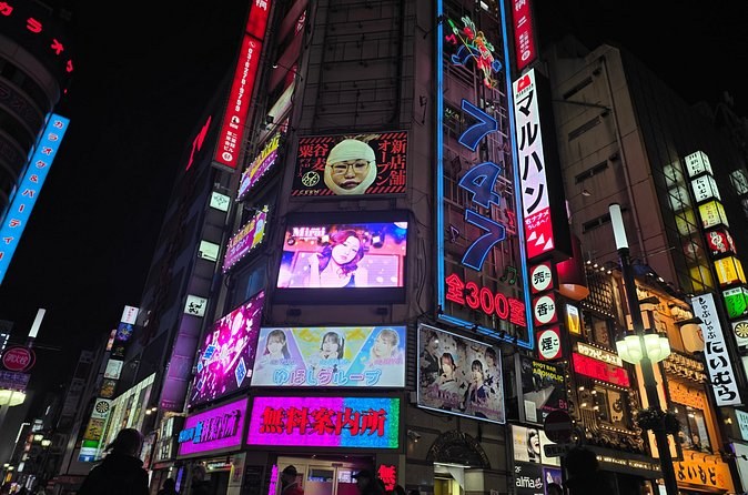 A corner building in Kabukicho covered in lit signs and video screens