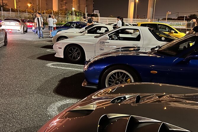 Sports cars parked in rows at the expressway car meet at night